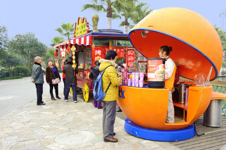 CHENGDU - FEB 3: woman in front of mobile store in an amusement park on Feb 3, 2011 in Chengdu, China.のeditorial素材