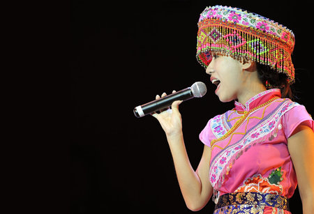 CHENGDU - SEP 28: chinese Miao ethnic singer performs on stage in the 6th Sichuan minority nationality culture festival at JINJIANG theater.Sep 28,2010 in Chengdu, China.のeditorial素材