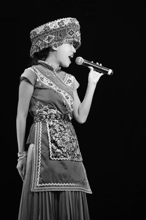 CHENGDU - SEP 28: chinese Miao ethnic singer performs on stage in the 6th Sichuan minority nationality culture festival at JINJIANG theater.Sep 28,2010 in Chengdu, China.のeditorial素材