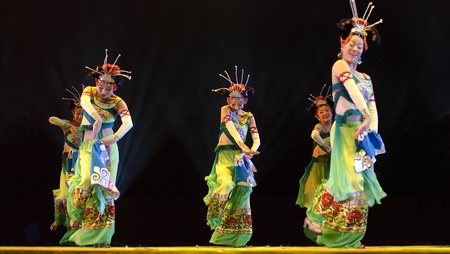 CHENGDU - DEC 13: chinese Yi ethnic dancers perform folk group dance on stage at JINCHENG theater in the 7th national dance competition of china on Dec 13,2007 in Chengdu, China.のeditorial素材