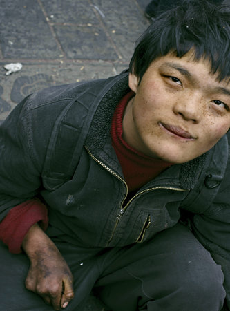 CHENGDU - FEB 14: a handicapped beggar begging on city street on Feb 14, 2010 in Chengdu, China. 