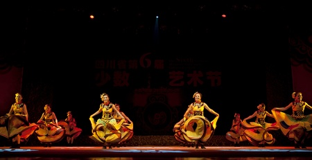 CHENGDU - SEP 28: chinese Yi ethnic dancers perform on stage in the 6th Sichuan minority nationality culture festival at JINJIANG theater.Sep 28,2010 in Chengdu, China.のeditorial素材