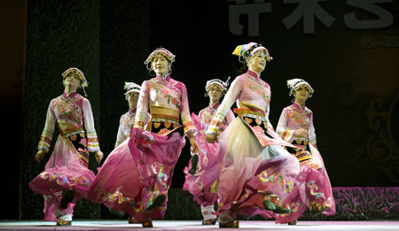 CHENGDU - SEP 28: chinese Yi ethnic dancers perform on stage in the 6th Sichuan minority nationality culture festival at JINJIANG theater.Sep 28,2010 in Chengdu, China.のeditorial素材