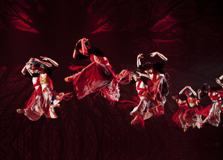CHENGDU - OCT 17: Chinese Yi national dancers perform contemporary dance on stage at JINCHENG theater on Oct 17, 2011 in Chengdu, China.のeditorial素材