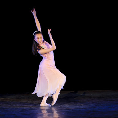 CHENGDU - DEC 15: Chinese dancer performs modern solo dance on stage at JINCHENG theater in the 7th...