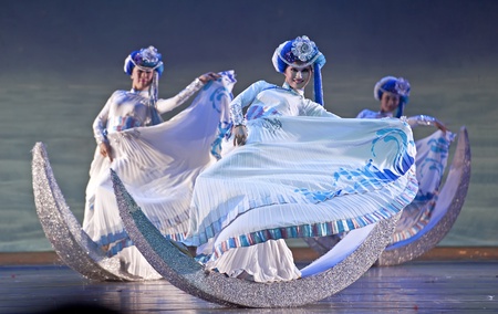 CHENGDU - OCT 18: Chinese Mosuo national dancers perform Lugu folk dance on stage at JINCHENG theater on Oct 18, 2011 in Chengdu, China.のeditorial素材