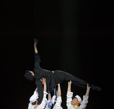 CHENGDU - DEC 10: modern dancers perform group dance on stage at JINCHENG theater in the 7th...