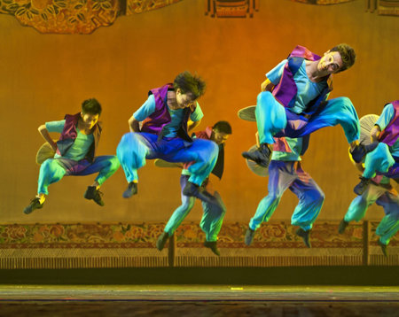 CHENGDU - OCT 17: Chinese national dancers perform folk dance on stage at JINCHENG theater on Oct 17, 2011 in Chengdu, China.のeditorial素材