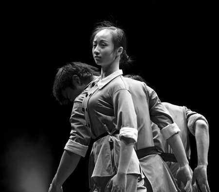 CHENGDU - DEC 9: chinese modern dancers perform trio dance on stage at JINCHENG theater in the 7th national dance competition of china.Dec 9,2007 in Chengdu, China.Choreographer & Cast: Xu Linlin, Zou Yan, Zhang Xiaodongのeditorial素材