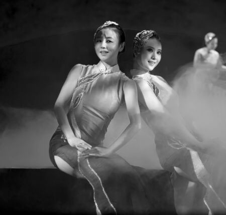 CHENGDU - OCT 17: Chinese national dancers perform folk dance on stage at JINCHENG theater on Oct 17, 2011 in Chengdu, China.のeditorial素材