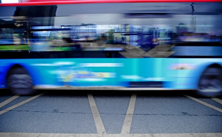 High speed and blurred bus trails on downtown roadの写真素材