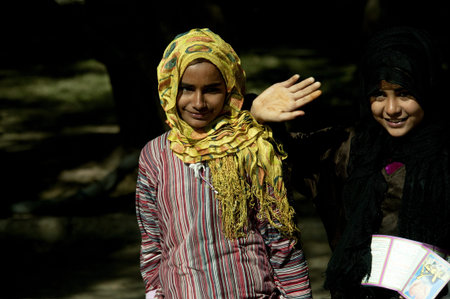 ALEXANDRIA - JAN 27: arab girls greeting photographer with a smile in the street at Alexandria.Jan 27,2013 in Alexandria,Egypt.のeditorial素材