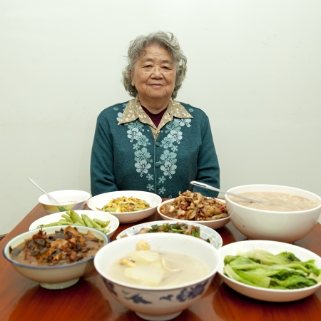 Sitting at the dinner table, happy grandmotherの写真素材