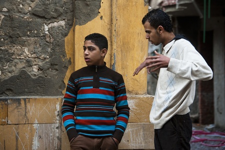 ALEXANDRIA - JAN 27: arab boys talking in the street at Alexandria.Jan 27,2013 in Alexandria,Egypt.のeditorial素材