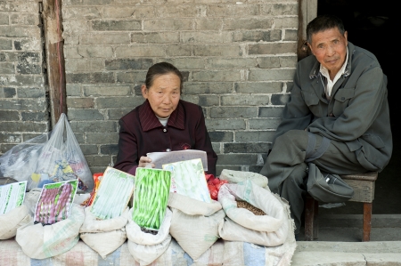 couple,roadside hawkers in a little townの写真素材