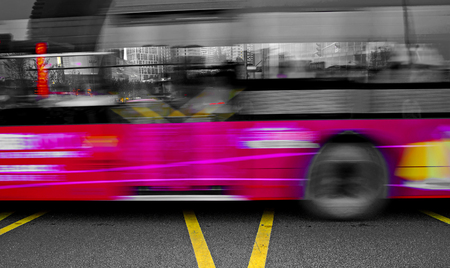 High speed and blurred bus trails on downtown roadの写真素材