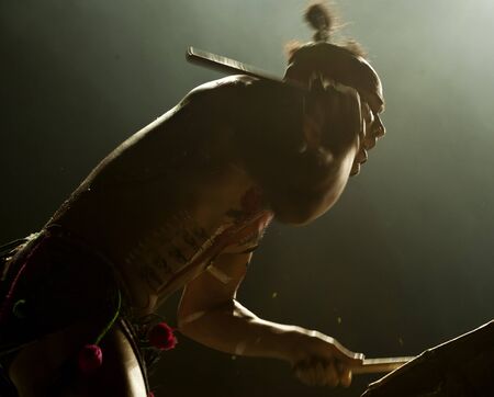CHENGDU - OCT 27: chinese national drummer playing drum on stage at Jincheng theater. Oct 27, 2011 in Chengdu, China.のeditorial素材