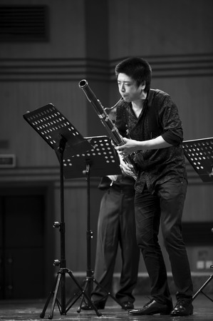 CHENGDU - JUN 20: bassoonist perform on wind music chamber music concert at odeum of Sichuan Conservatory of Music on Jun 20,2012 in Chengdu,China.のeditorial素材