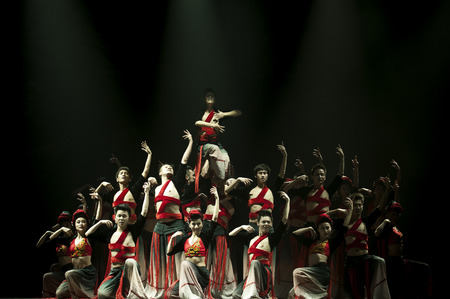 CHENGDU - OCT 17: Chinese Yi national dancers perform contemporary dance on stage at JINCHENG theater on Oct 17, 2011 in Chengdu, China.のeditorial素材