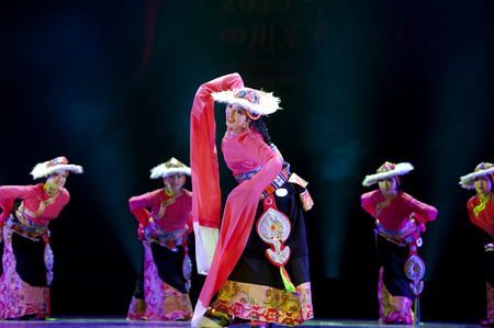 CHENGDU - APR 12: Ganzi national song and dance troupe perform tibetan national dance "merry songs and step dance" at sichuan song and dance theater in the new works for 2013 dance competition in Sichuan.のeditorial素材