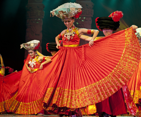CHENGDU - SEP 26: chinese Yi ethnic dancers perform on stage at JIAOZI theater.のeditorial素材