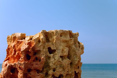 Limestone relief with deep holes on the background seaの写真素材
