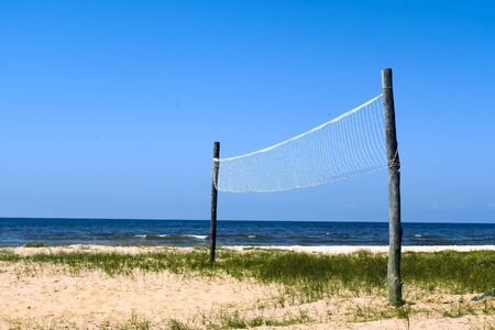 Volleyball net at the wild seashoreの写真素材