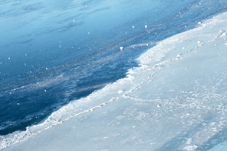 Strand quickly frozen thin ice on a reservoir. Early winterの写真素材