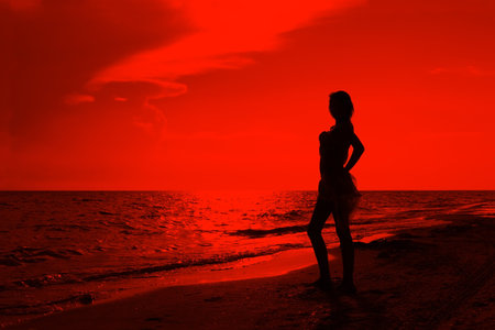 Teenage girl on the beach at sunset. Processed Editorの写真素材