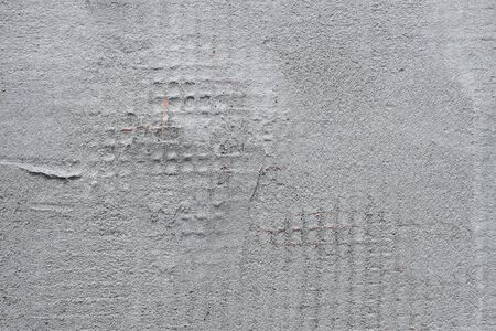 Detail of a wall covered with plastic mesh and construction glueの写真素材