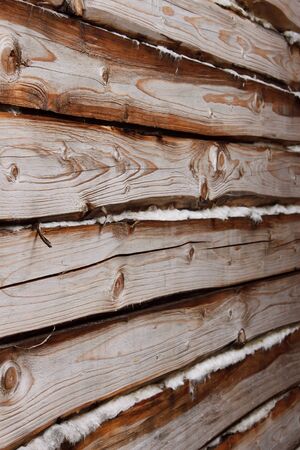 Detail of a wall of parallel wooden logs with insulation between themの写真素材