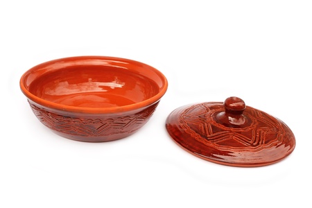 Annealed clay pot with a cover for cooking and prolonged storage of hot dishes. Isolated on white backgroundの写真素材