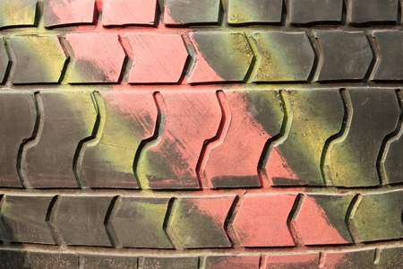 A fragment of an old automobile tire with the surface painted in different colorsの写真素材