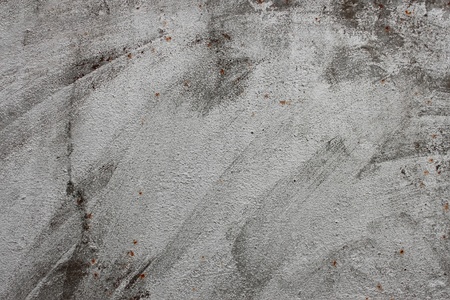A fragment of metal sheet partially covered with white paintの写真素材