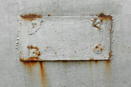 Fragment of old metal surface with welded rectangular patch. Dyed in silver colorの写真素材