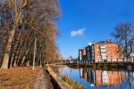 City house above the river canal near the old park. Late autumn urban landscapeの写真素材