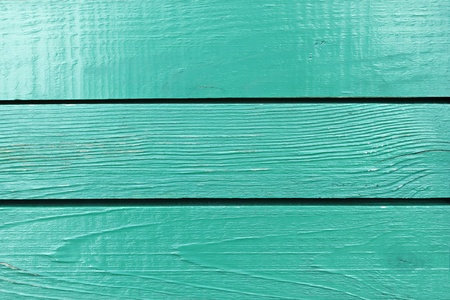 Fragment of wooden fence painted in bright aquamarineの写真素材