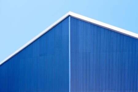 Detail the roof of parallel sheets of metal against a blue skyの写真素材