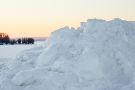 High snow hummock against the evening sky after sunset in winterの写真素材