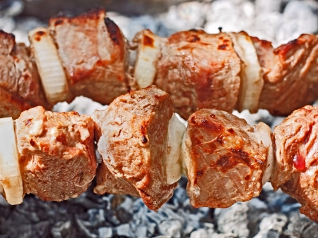 Meat on skewers roasted in chargrill close upの写真素材