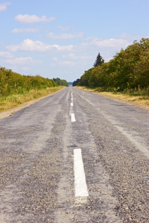 Rural roads covered with asphalt in summertimeの写真素材