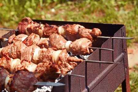 Kebabs grilled on metal skewers outdoors in summertimeの写真素材