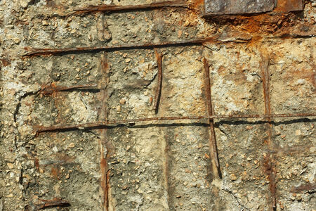 Fragment of old obsolete reinforced concrete structures with rusty iron rods outsideの写真素材