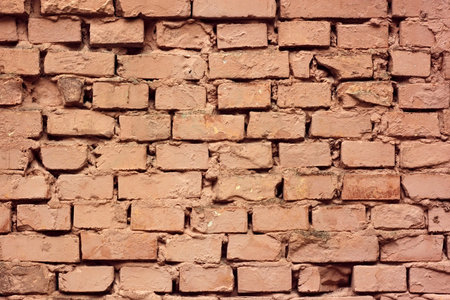 Detail of painted old brick wall covered with colored lime layers