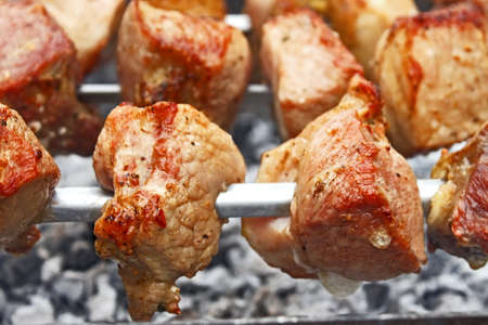 Shashlik (shish kebab) prepared on the metal skewers close-upの写真素材