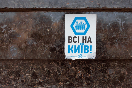 KHMELNYTSKY, UKRAINE - OCTOBER 05, 2014: Old paper notice on the dark marble wall urges the people to ride in Kyiv to protest against the anti-democratic actions of the old government. This message dated approximately from December 2013 to February 2014.のeditorial素材