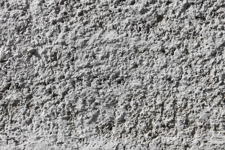 Fragment of concrete wall painted with white limeの写真素材