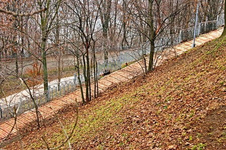 Park paved alley that runs steeply down, early spring in Kyiv, Ukraineの写真素材