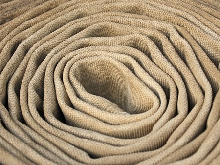 Old rolled dirty fire hose fabric close-upの写真素材