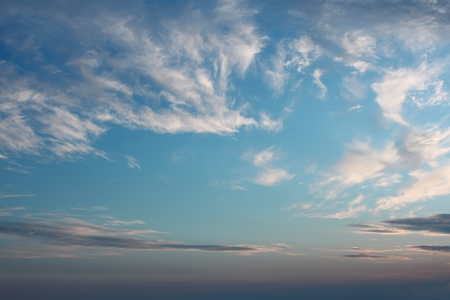 Heaven, beautiful cloudscape of light white and dark clouds against blue sky after sunsetの写真素材